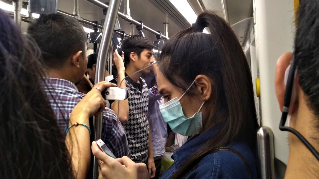 Woman wearing a mask in the skytrain